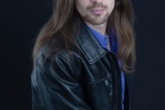 young male head shot dark